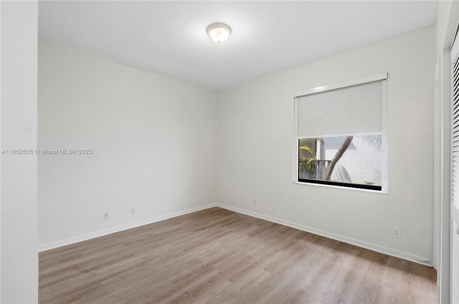 2449 Northwest 64th Street Boca Raton, FL 33496 - Photo 11 of 50 an empty room with a painting on the wall