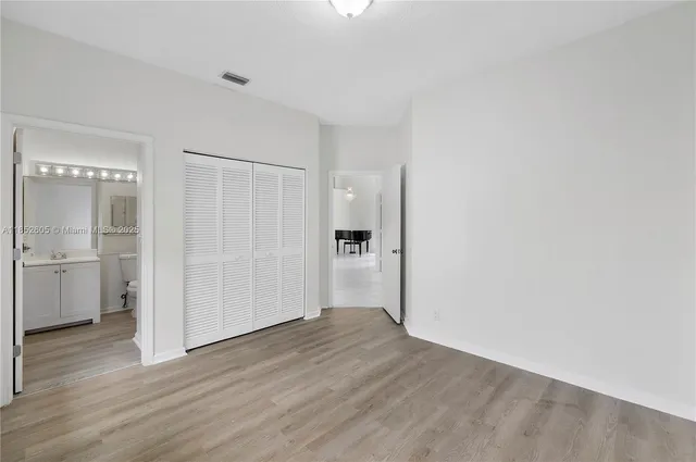 a bathroom with a sink toilet vanity and shower