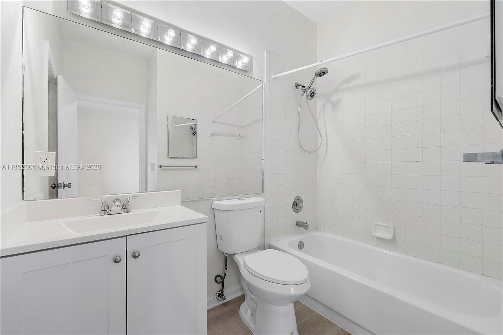 2449 Northwest 64th Street Boca Raton, FL 33496 - Photo 13 of 50 a bathroom with a sink toilet vanity and shower
