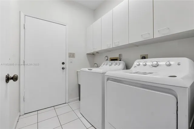 a kitchen with a refrigerator sink and cabinets