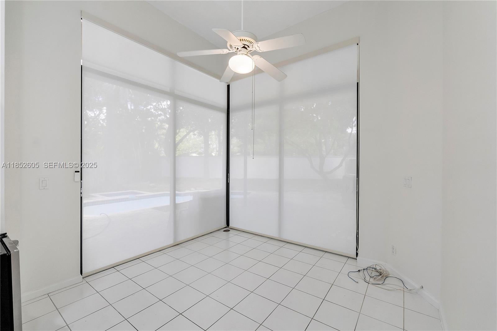 2449 Northwest 64th Street Boca Raton, FL 33496 - Photo 21 of 50 a view of an empty room and chandelier fan