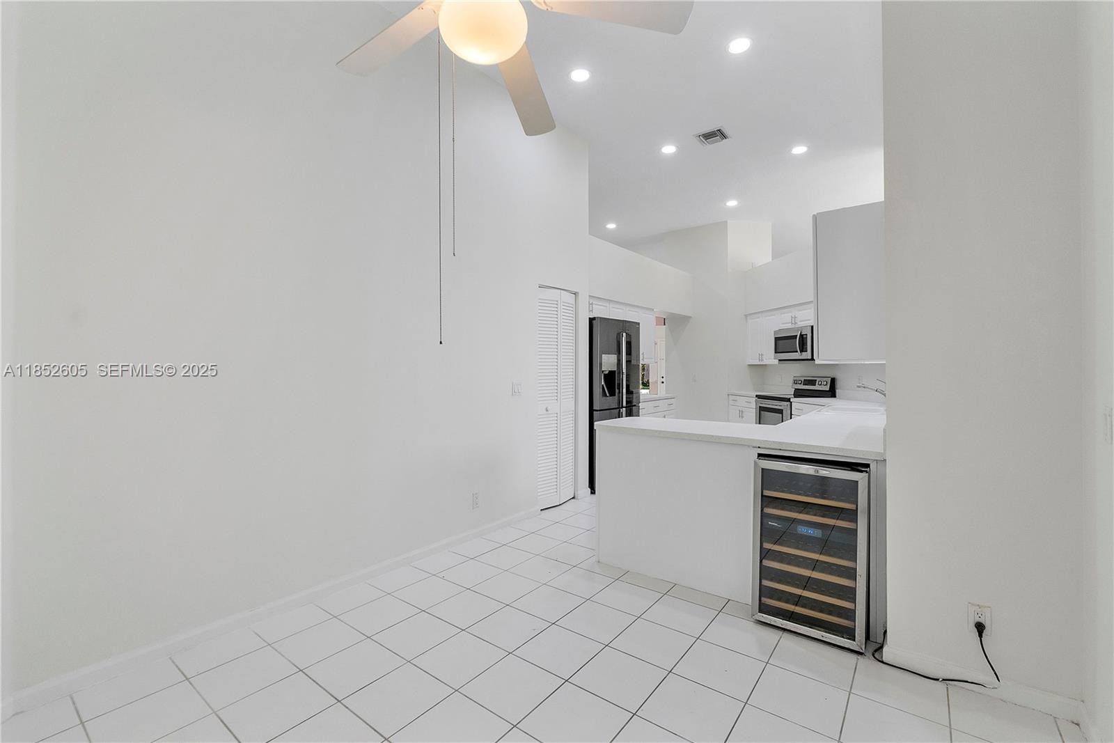 2449 Northwest 64th Street Boca Raton, FL 33496 - Photo 22 of 50 a kitchen with white cabinets and white appliances