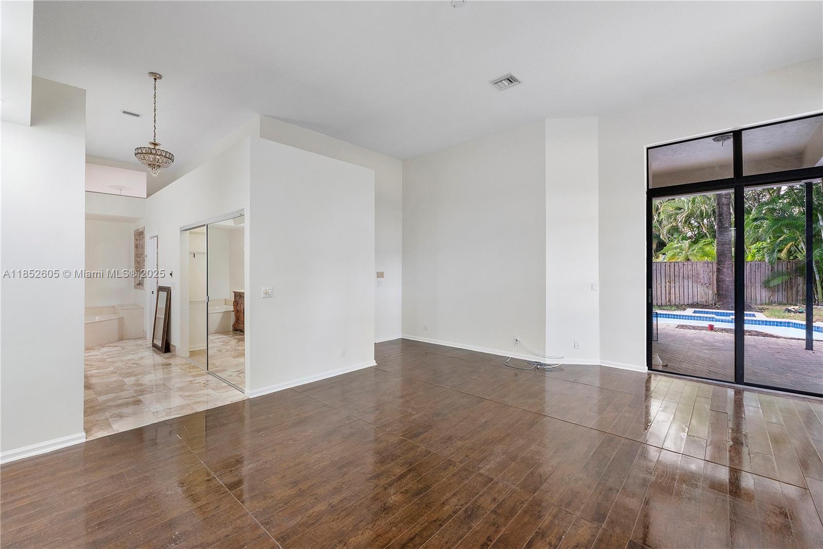 2449 Northwest 64th Street Boca Raton, FL 33496 - Photo 26 of 50 a view of empty room with wooden floor and fan