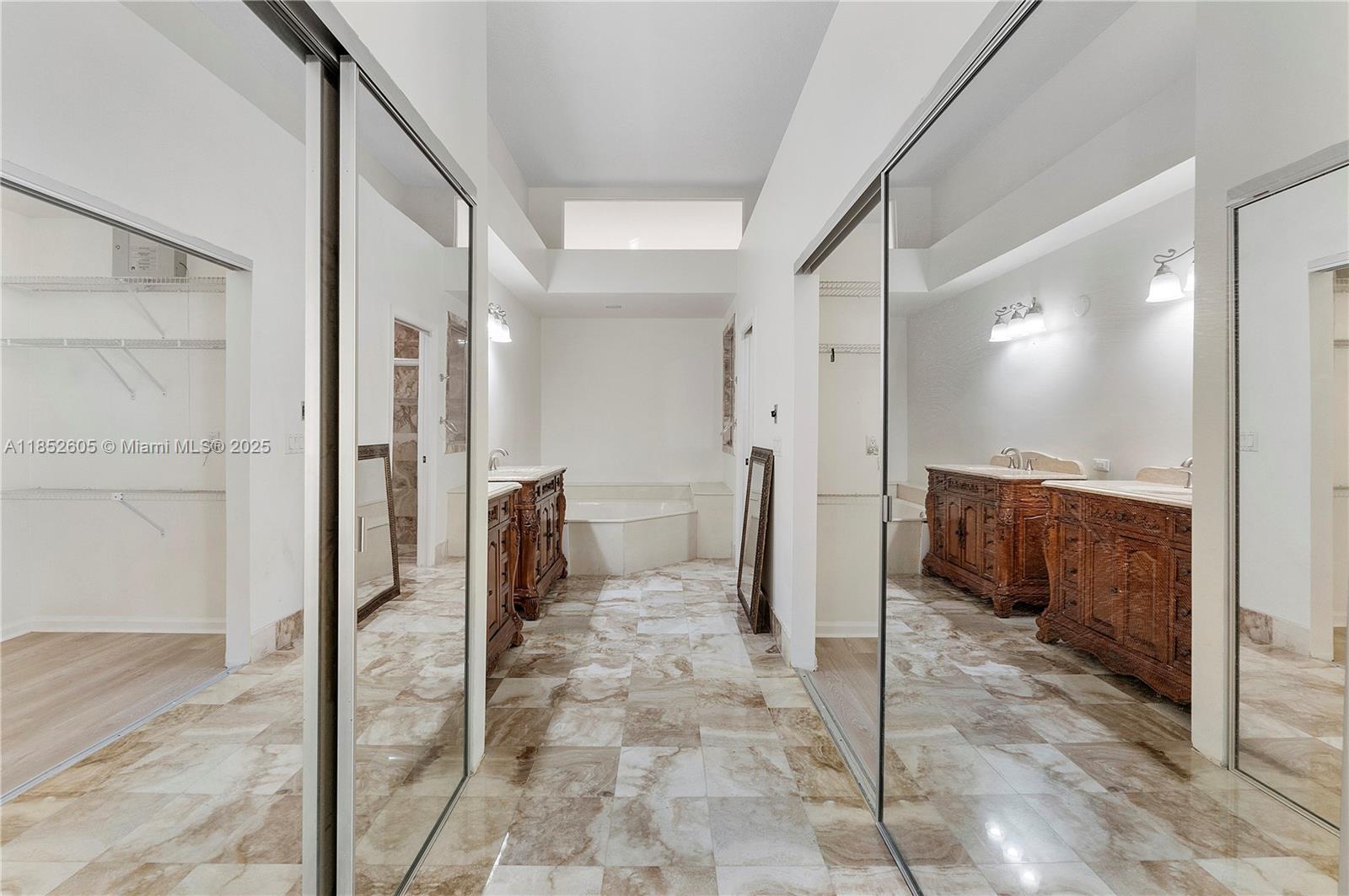 2449 Northwest 64th Street Boca Raton, FL 33496 - Photo 27 of 50 a bathroom with a glass shower door a sink and a mirror