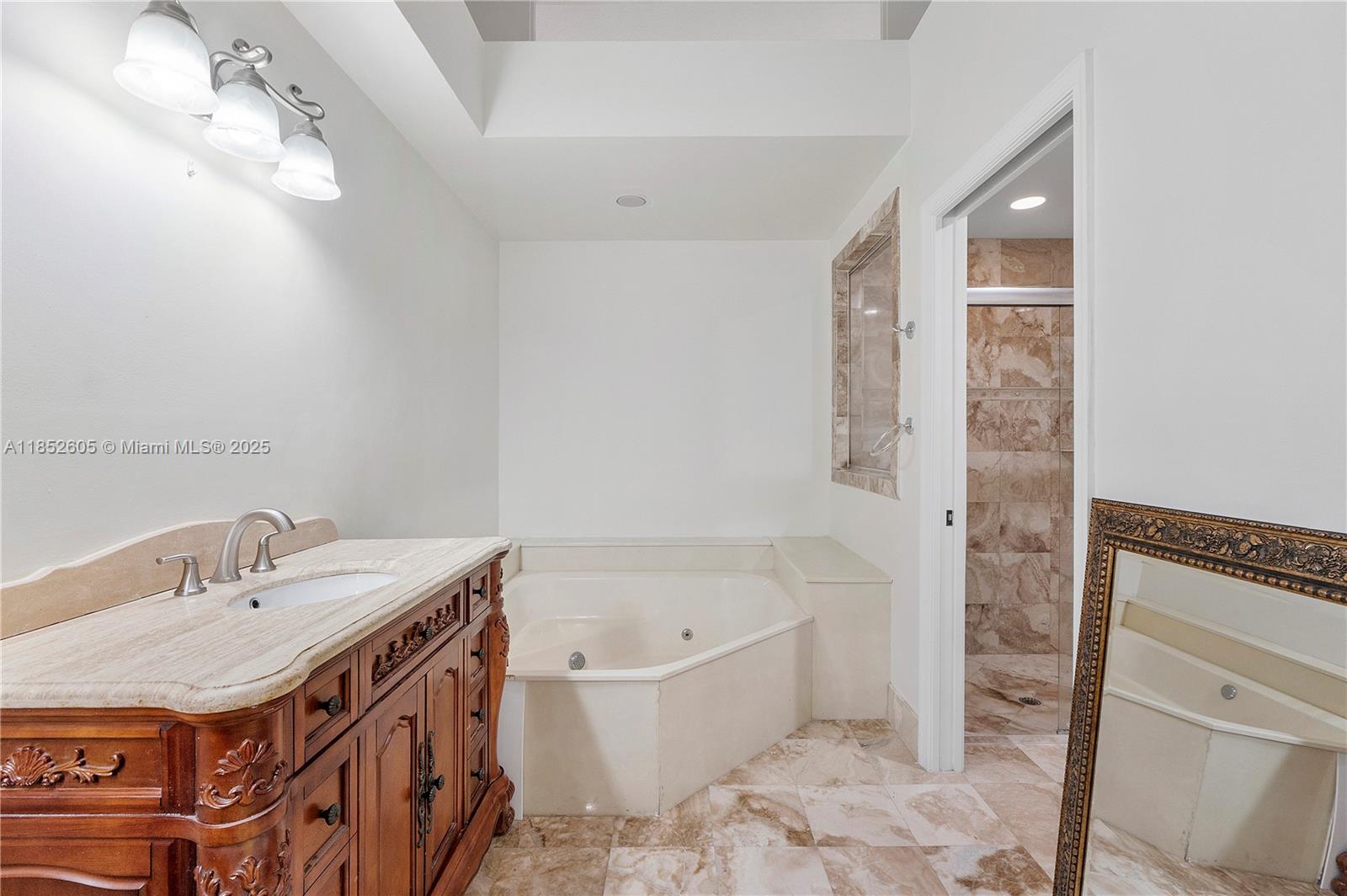 2449 Northwest 64th Street Boca Raton, FL 33496 - Photo 29 of 50 a spacious bathroom with a bathtub sink and a mirror