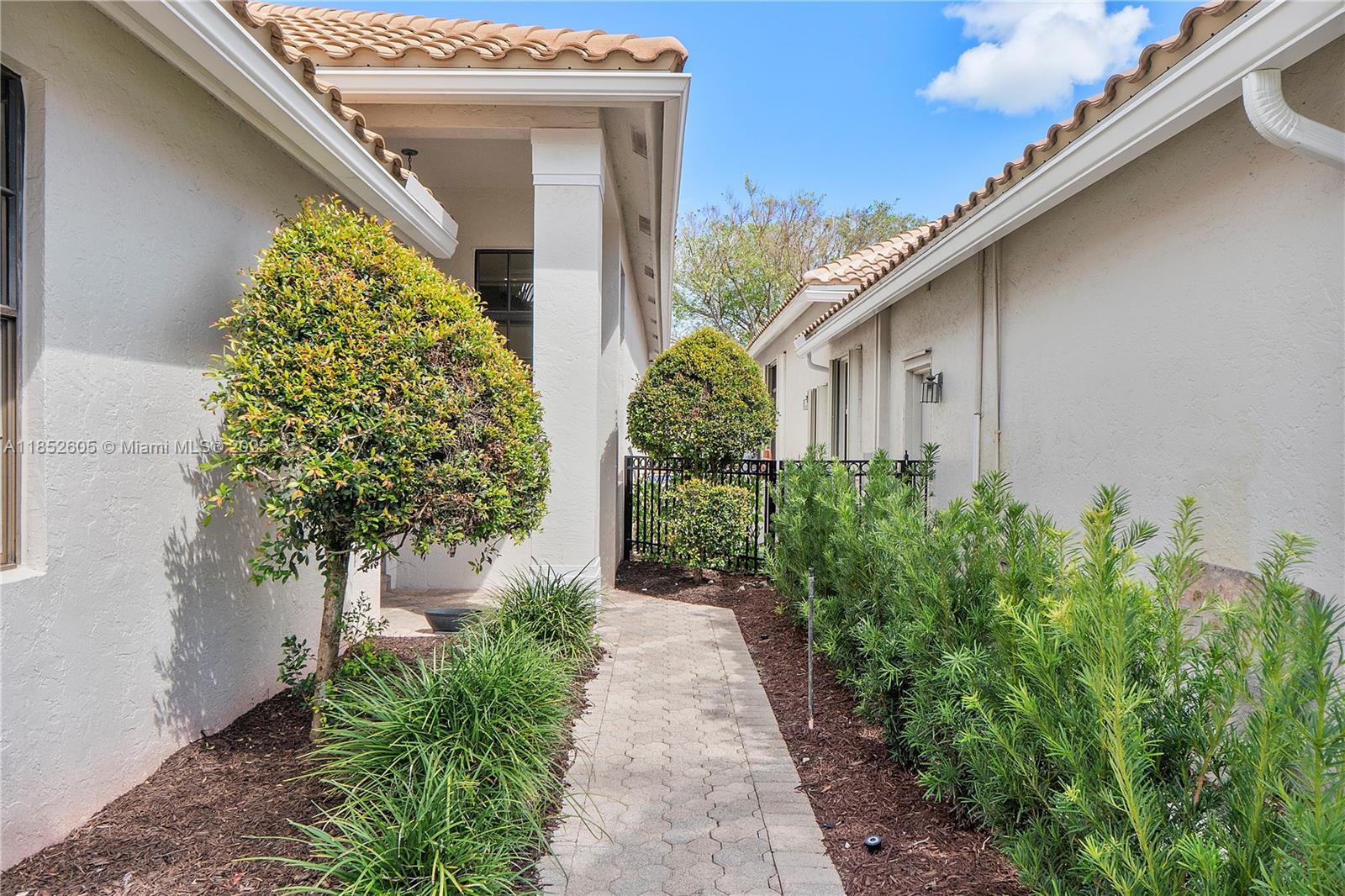 2449 Northwest 64th Street Boca Raton, FL 33496 - Photo 5 of 50 a front view of a house with garden