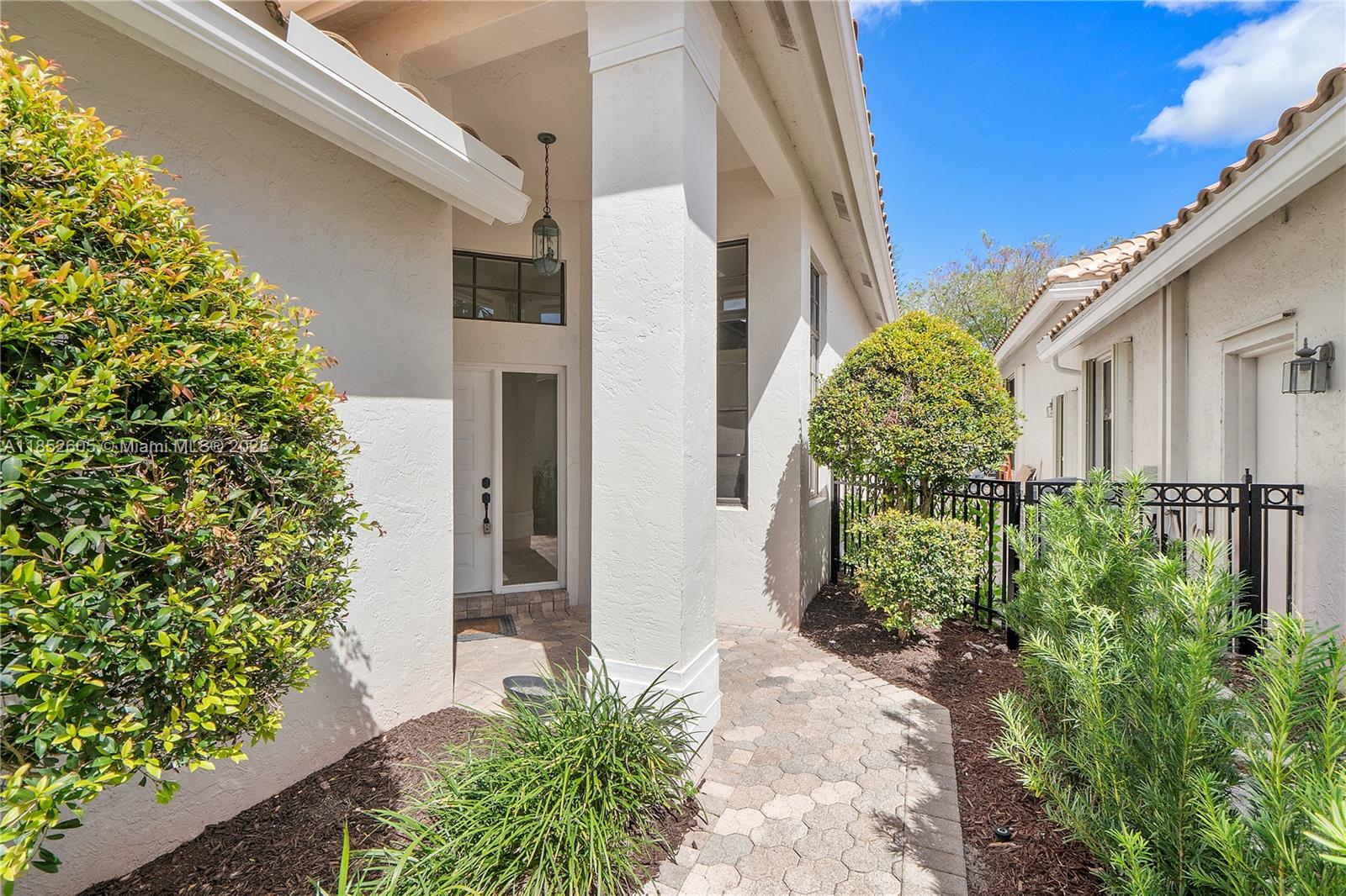 2449 Northwest 64th Street Boca Raton, FL 33496 - Photo 6 of 50 a couple of potted plants in front of door