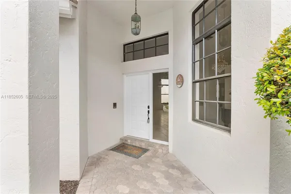 a living room with furniture a ceiling fan and a window