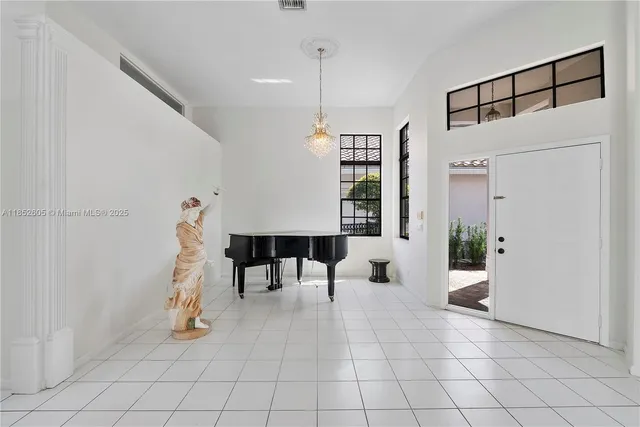 an empty room with a painting on the wall