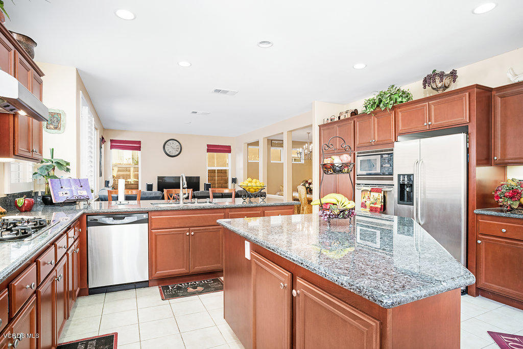 13709 Swift Run Street Moorpark, CA 93021 - Photo 13 of 34 a kitchen with stainless steel appliances granite countertop a sink stove and refrigerator