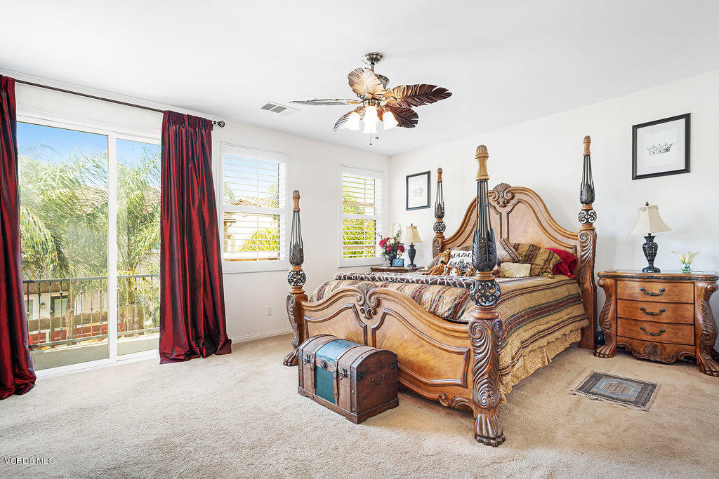 13709 Swift Run Street Moorpark, CA 93021 - Photo 17 of 34 a bedroom with a bed and a chandelier