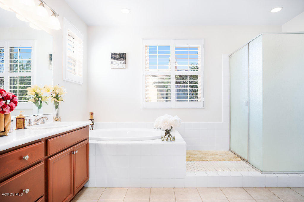 13709 Swift Run Street Moorpark, CA 93021 - Photo 21 of 34 a bathroom with a tub sink and mirror