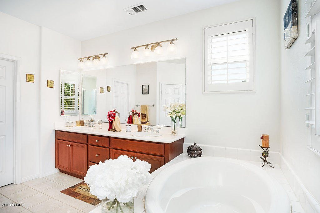 13709 Swift Run Street Moorpark, CA 93021 - Photo 22 of 34 a bathroom with a tub sink and mirror
