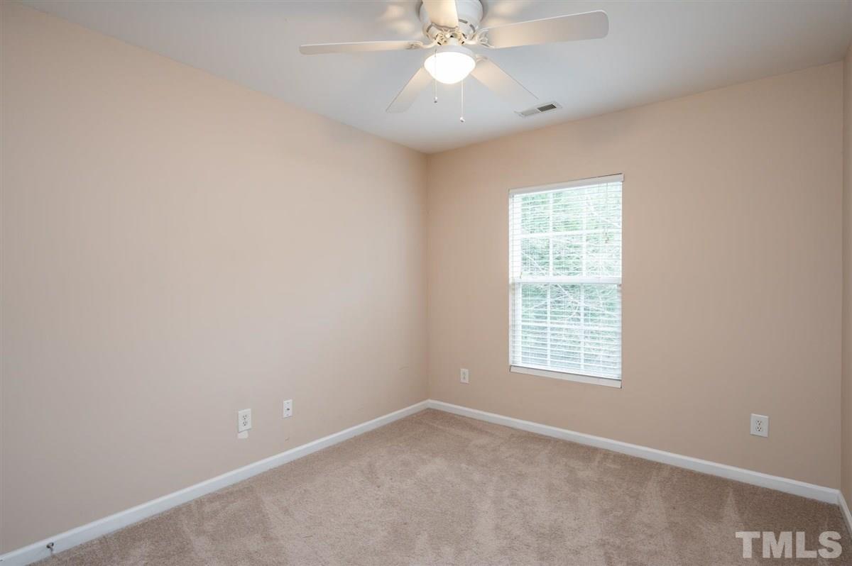 8311 Clasara Circle Raleigh, NC 27613 - Photo 22 of 27 an empty room with a window and a fan
