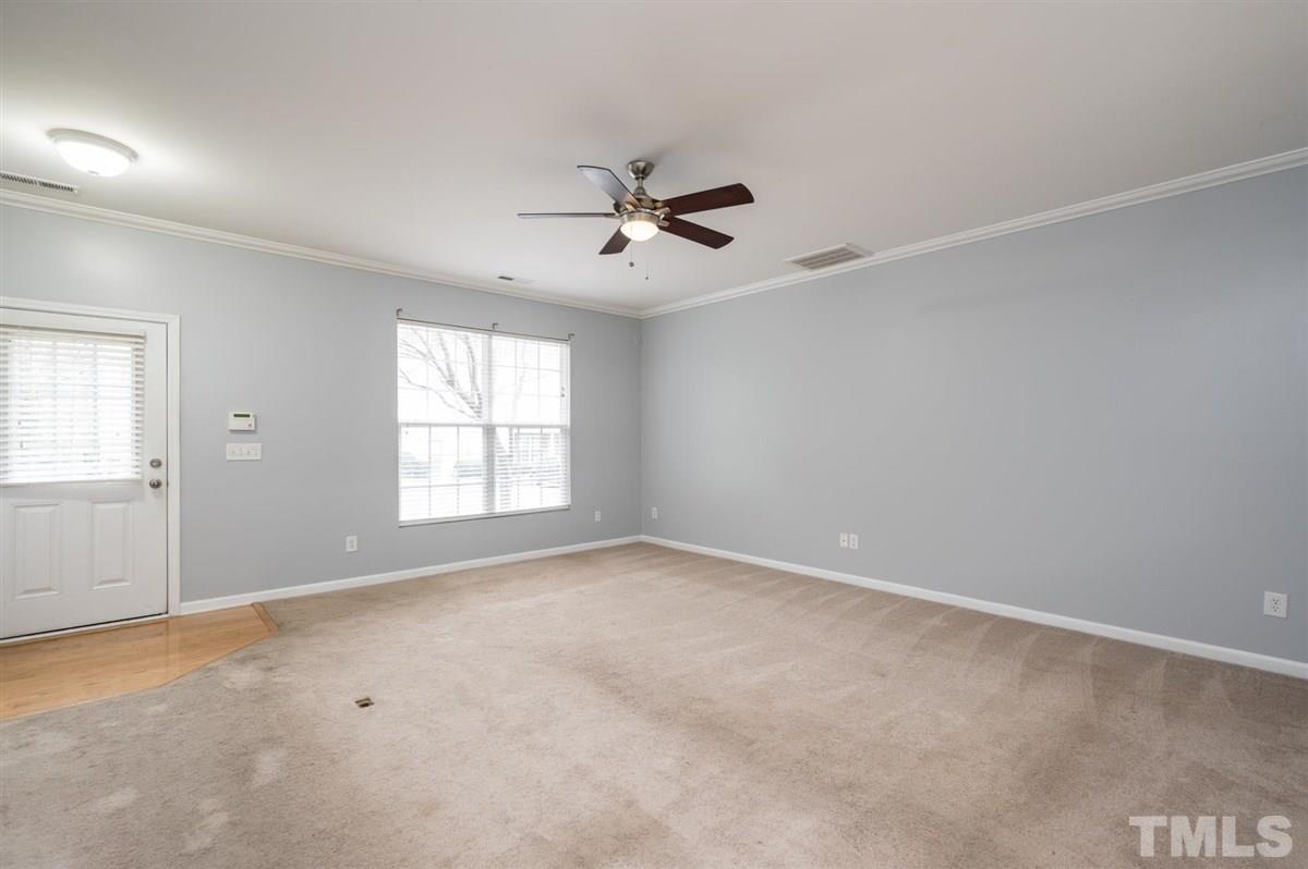 8311 Clasara Circle Raleigh, NC 27613 - Photo 7 of 27 an empty room with windows and fan