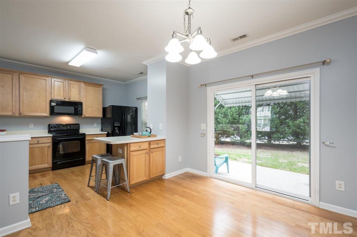 8311 Clasara Circle Raleigh, NC 27613 - Photo 8 of 27 a large white kitchen with a window and a fireplace