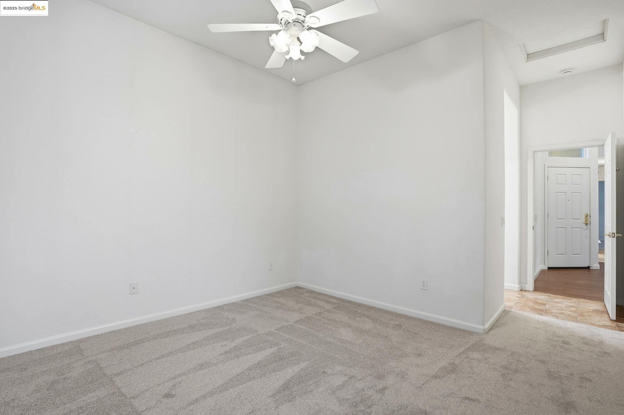 385 Ruby Terrace Brentwood, CA 94513 - Photo 13 of 37 an empty room with a fan and a window