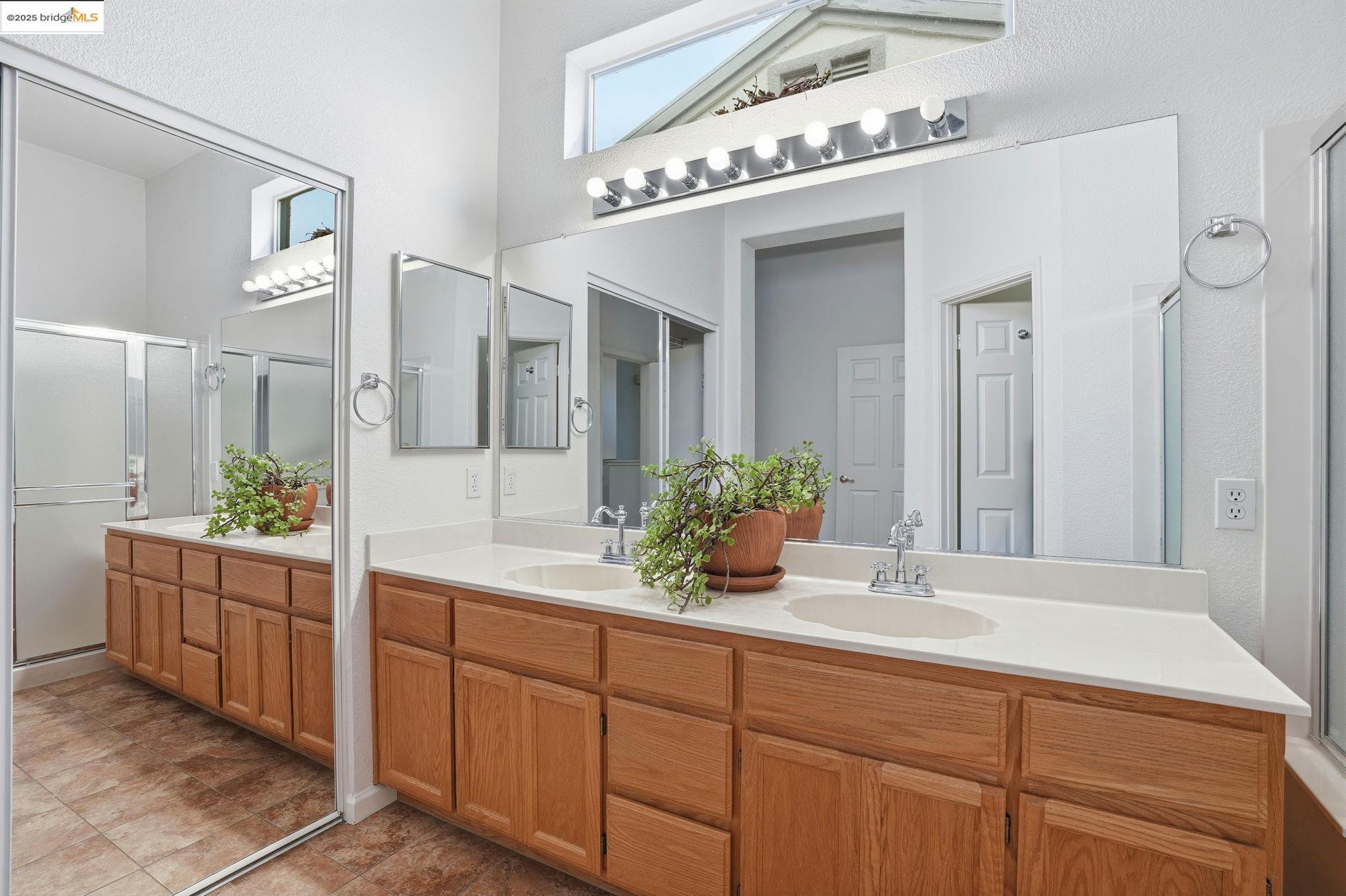 385 Ruby Terrace Brentwood, CA 94513 - Photo 16 of 37 a bathroom with a double vanity sink and mirror