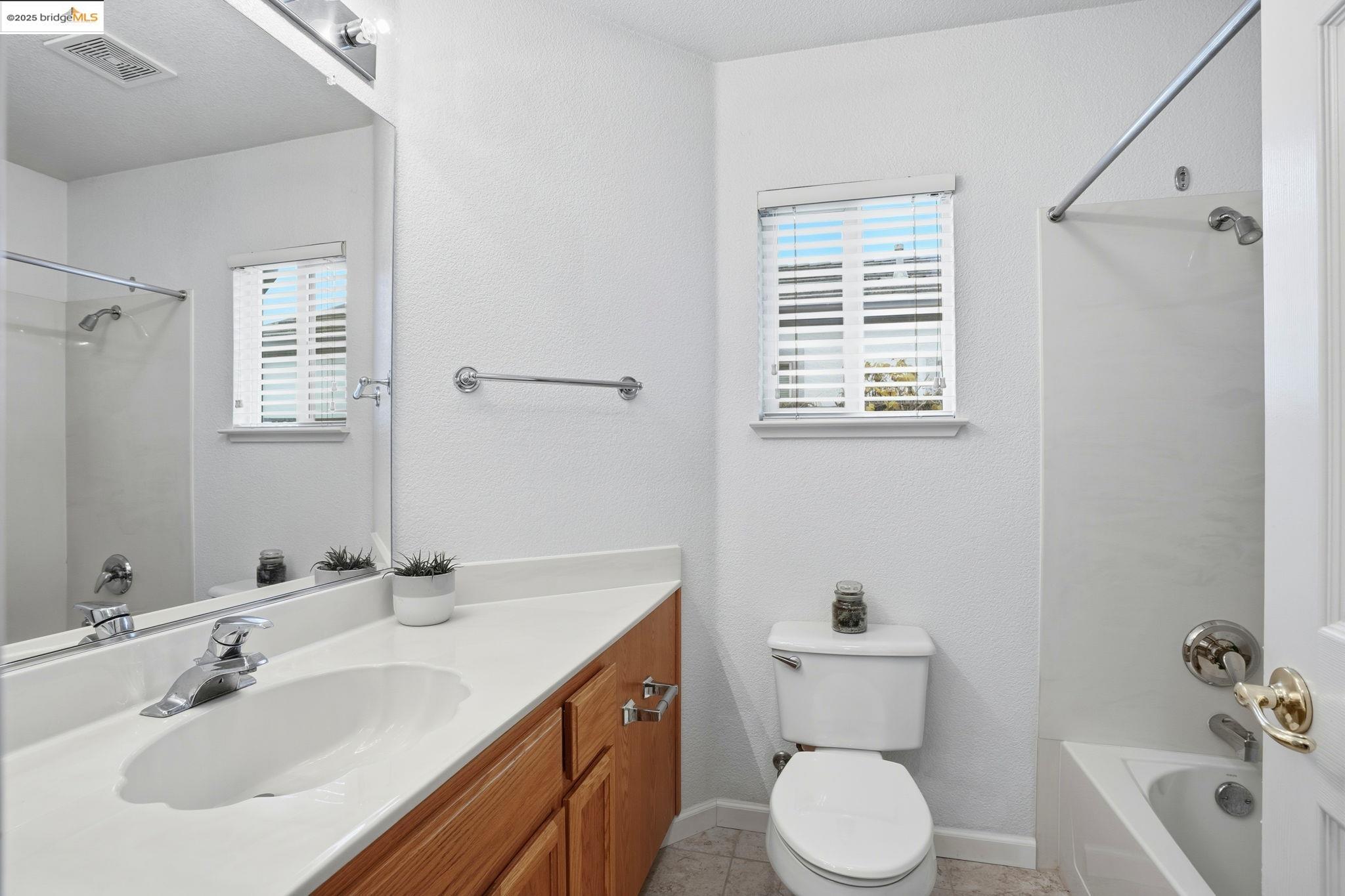 385 Ruby Terrace Brentwood, CA 94513 - Photo 20 of 37 a bathroom with a toilet sink and mirror