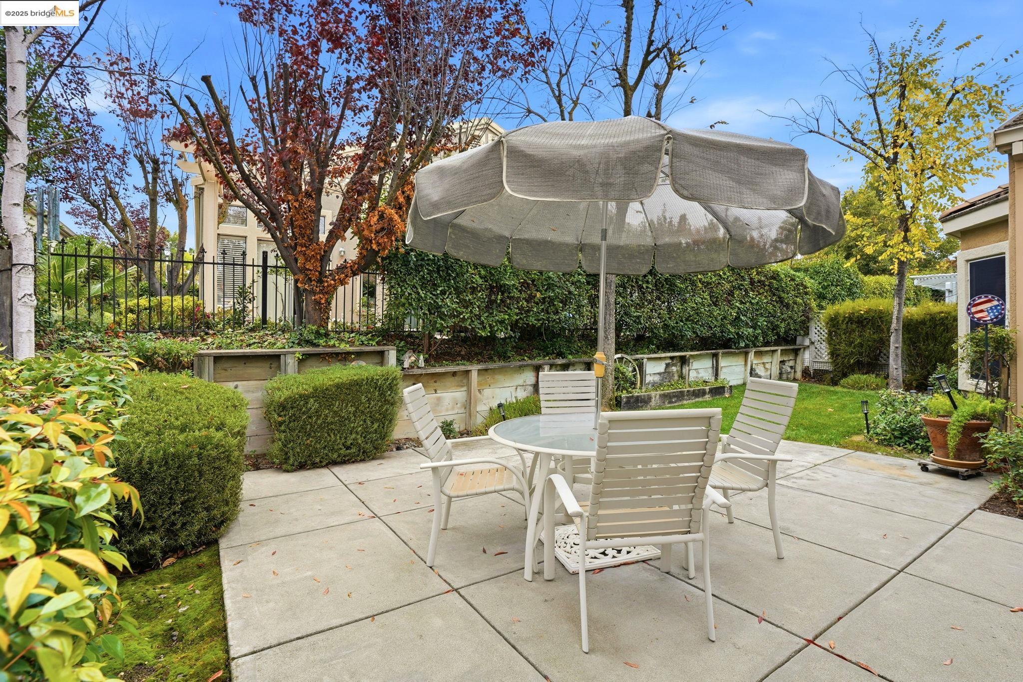 385 Ruby Terrace Brentwood, CA 94513 - Photo 22 of 37 a view of a table and chairs under an umbrella
