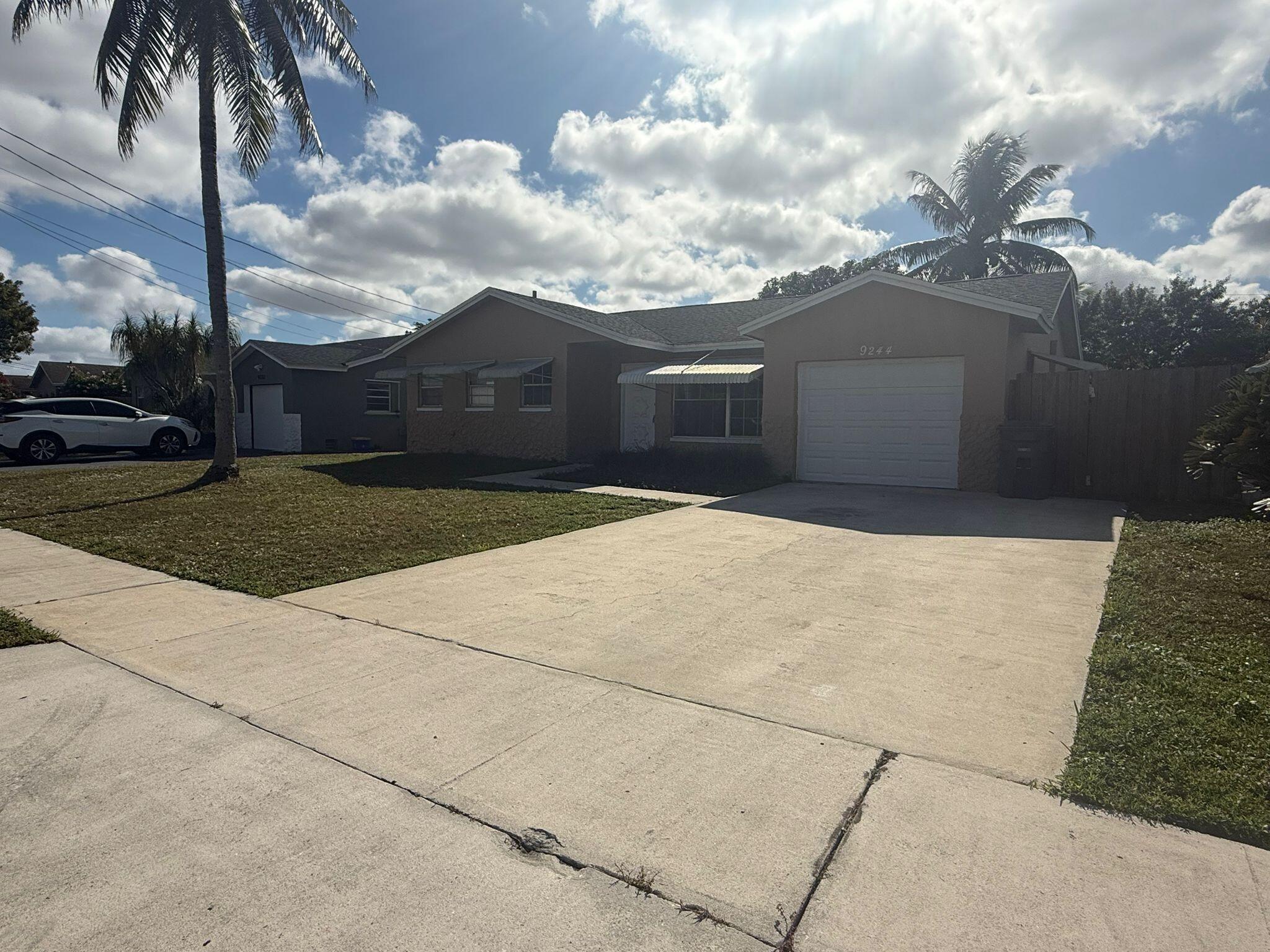 9244 Southwest 2nd Street Boca Raton, FL 33428 - Photo 1 of 11 a front view of a house with a yard
