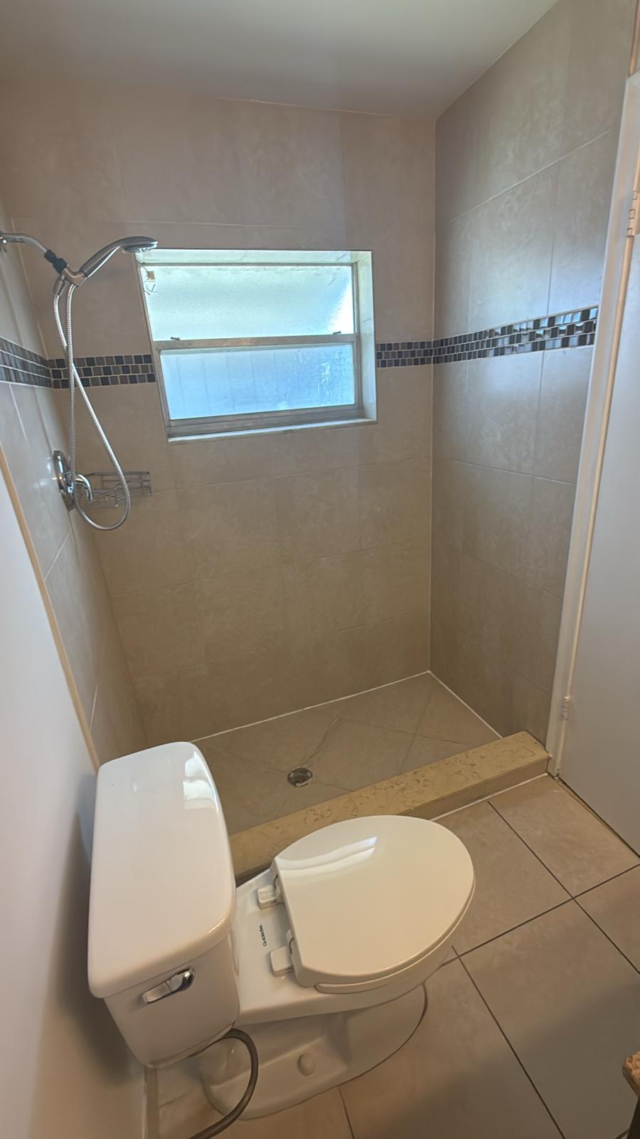 9244 Southwest 2nd Street Boca Raton, FL 33428 - Photo 9 of 11 a bathroom with a toilet and a mirror