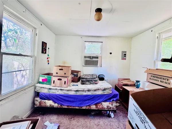 a bed room with bed and window