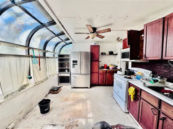 a kitchen with stainless steel appliances kitchen island granite countertop a sink and cabinets