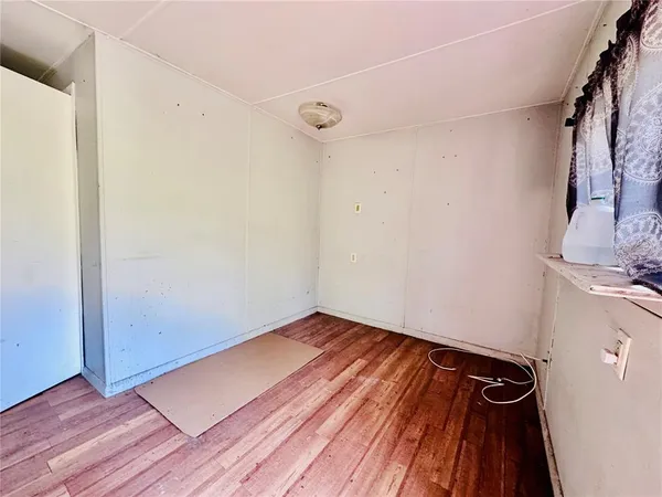 a view of a room with wooden floor and a sink