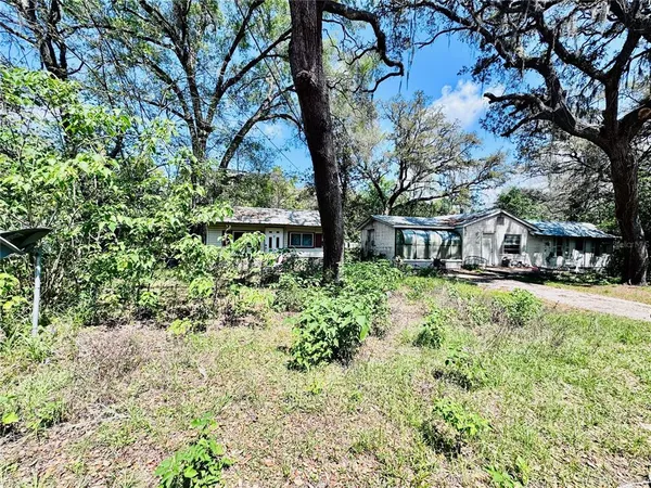 a view of house with yard