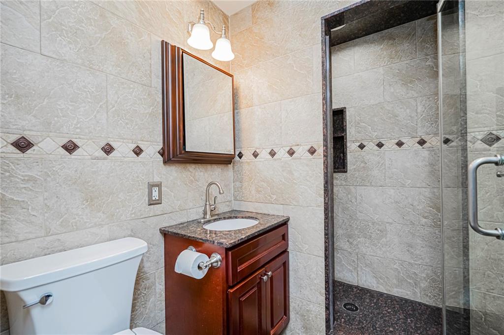 248 Bay 19th Street, Unit B Brooklyn, NY 11214 - Photo 12 of 14 a bathroom with a sink toilet and shower