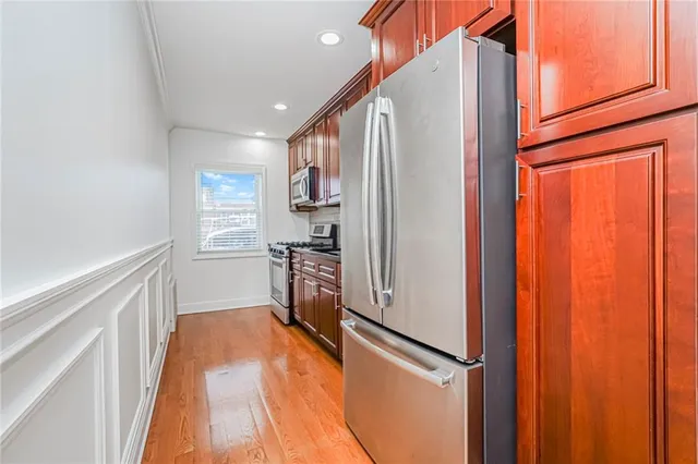 a kitchen with stainless steel appliances a refrigerator and a stove top oven