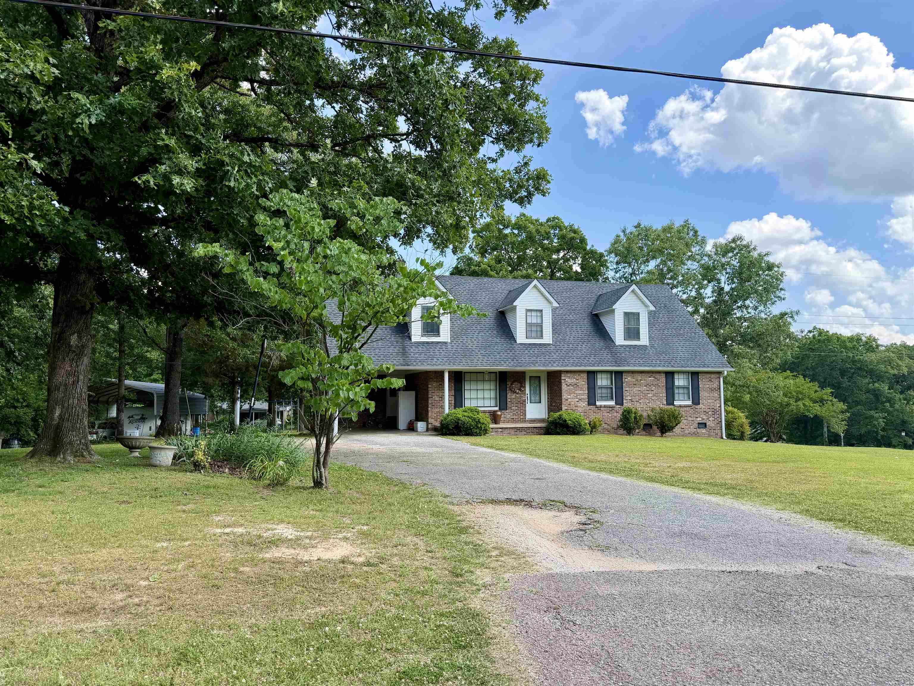 142 Treece Street Selmer, TN 38375 - Photo 34 of 36 Brick exterior residence with a dormer roofline and a paved driveway