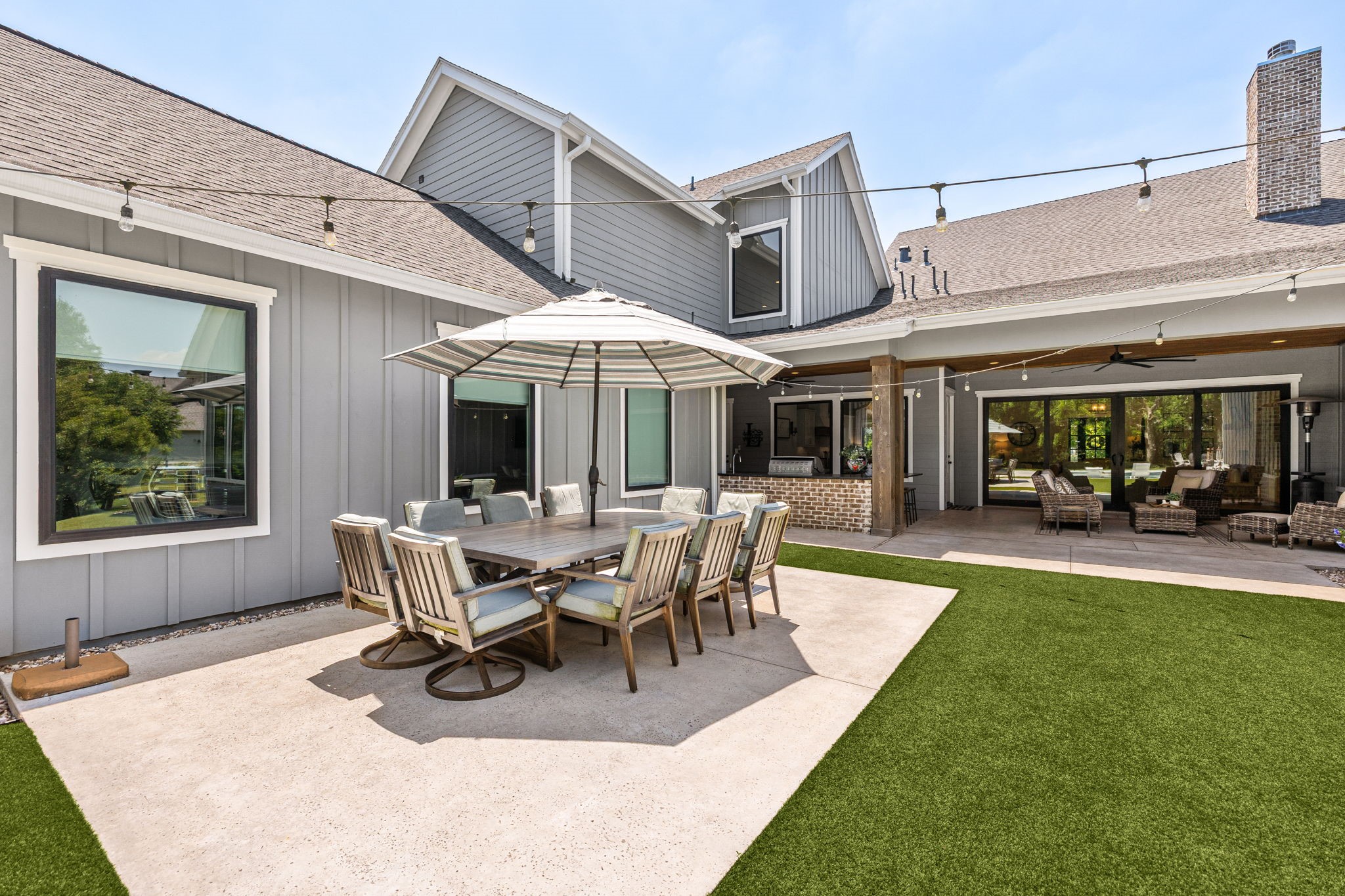 4311 Upper Oxbow Trace Fulshear, TX 77441 - Photo 39 of 49 Outdoor dining area perfectly positioned beside the covered patio and pool for effortless entertaining and al fresco meals.