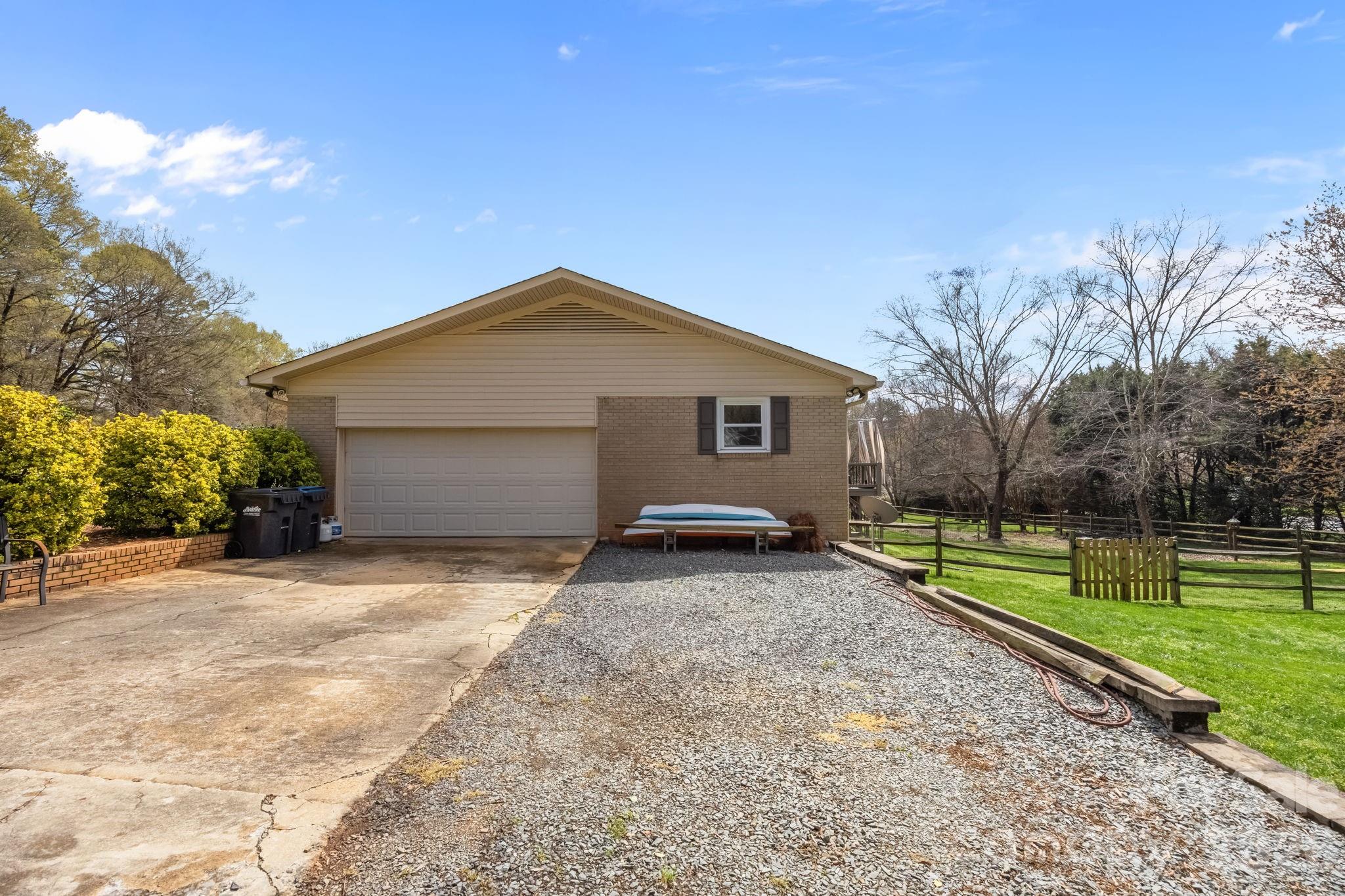 1141 Doby Court Fort Mill, SC 29715 - Photo 39 of 48 a backyard of a house with wooden fence and large trees