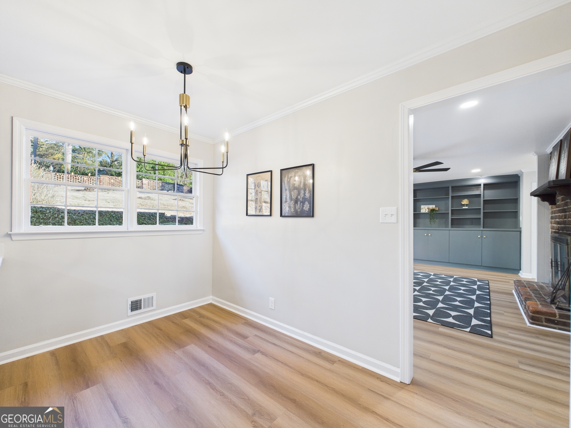 511 Pierce Avenue Macon, GA 31204 - Photo 15 of 57 a view of an empty room with a window and wooden floor