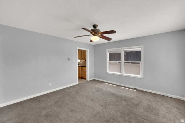 291 800 East Bountiful, UT 84010 - Photo 4 of 20 Carpeted room with light gray walls, white trim, and a ceiling fan with integrated lighting