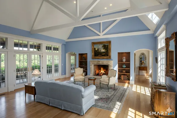 a living room with fireplace furniture and a large window