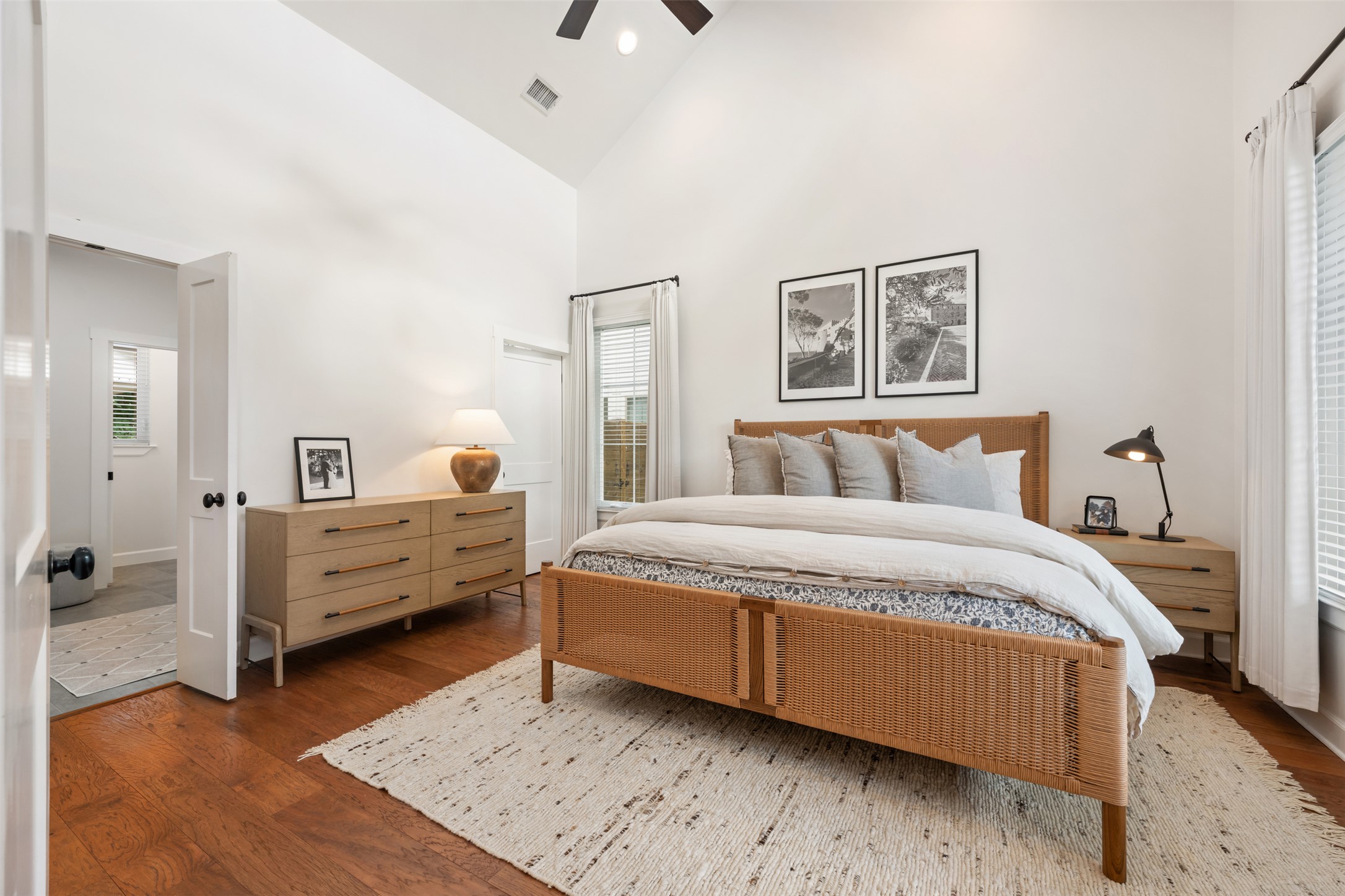 1301 West Street Georgetown, TX 78626 - Photo 18 of 40 Hardwood floors and a vaulted ceiling create a spacious feel in this well-appointed sleeping area.