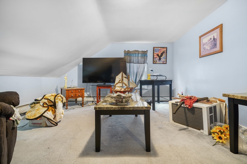 377 Hartwell Street Fall River, MA 02721 - Photo 11 of 31 a living room with furniture gym equipment and a flat screen tv