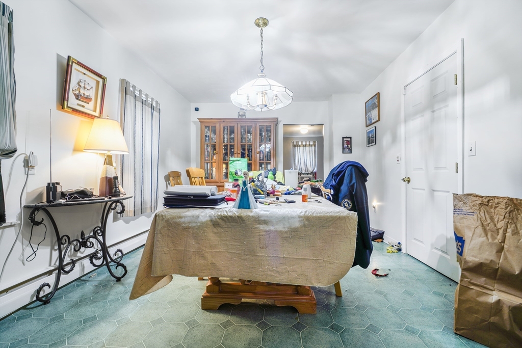 377 Hartwell Street Fall River, MA 02721 - Photo 15 of 31 a bed room with furniture and a chandelier