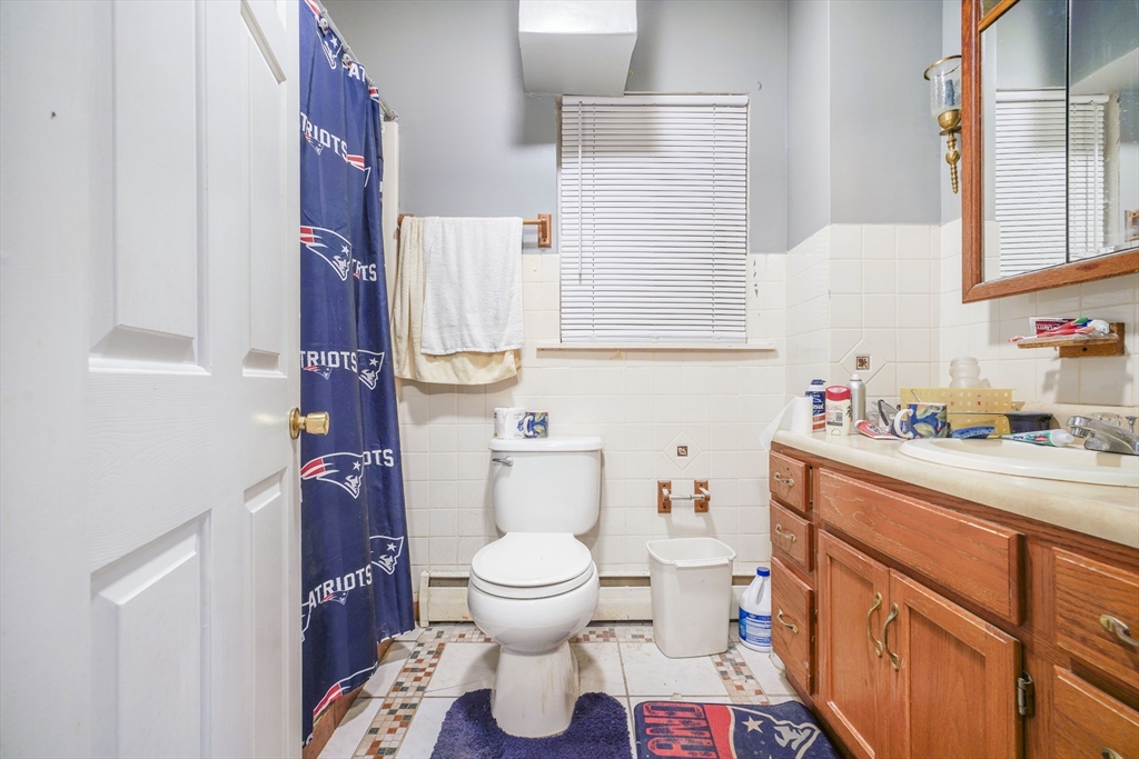377 Hartwell Street Fall River, MA 02721 - Photo 19 of 31 a bathroom with a sink toilet vanity and window