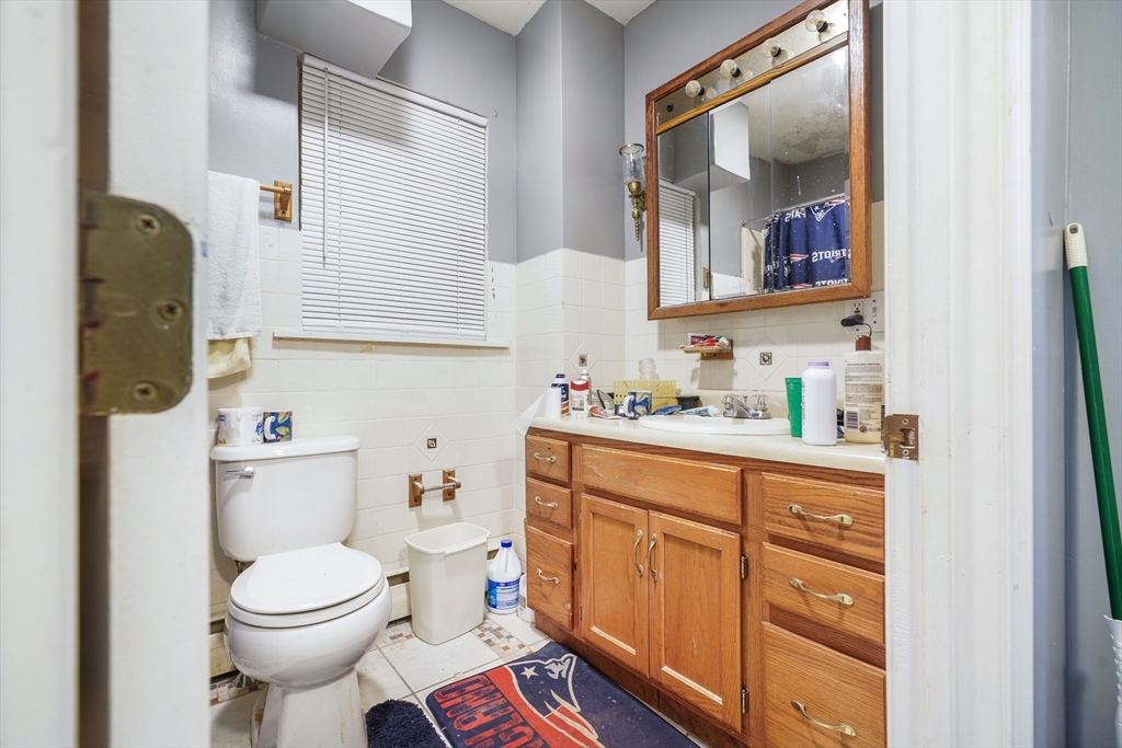 377 Hartwell Street Fall River, MA 02721 - Photo 20 of 31 a bathroom with a toilet sink and mirror