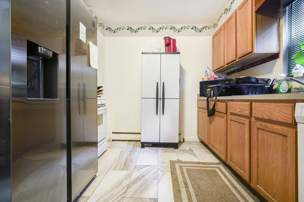 377 Hartwell Street Fall River, MA 02721 - Photo 22 of 31 a view of a refrigerator in kitchen and an empty room