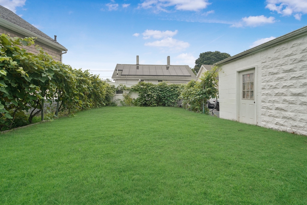 377 Hartwell Street Fall River, MA 02721 - Photo 3 of 31 a view of a backyard with plants and a big yard
