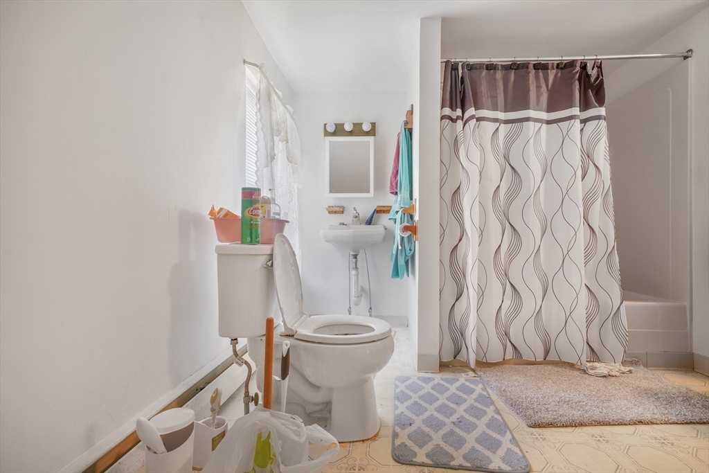 377 Hartwell Street Fall River, MA 02721 - Photo 7 of 31 a bathroom with a sink toilet and shower curtain