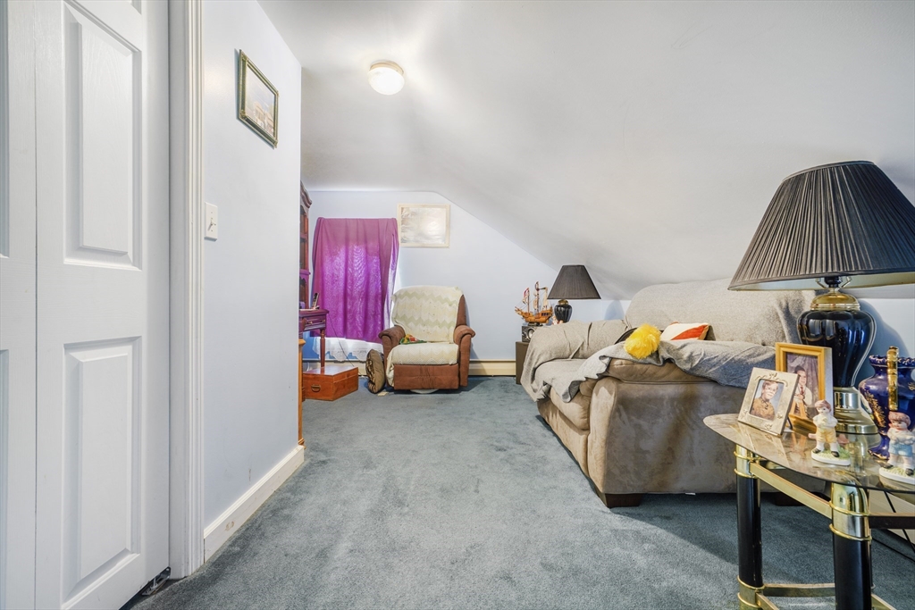 377 Hartwell Street Fall River, MA 02721 - Photo 8 of 31 a living room with furniture and a baby crib