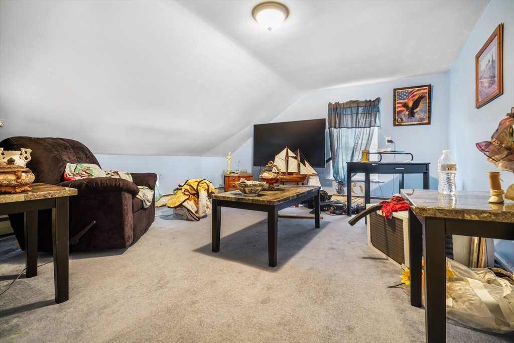 377 Hartwell Street Fall River, MA 02721 - Photo 10 of 31 a living room with furniture and a gym equipment