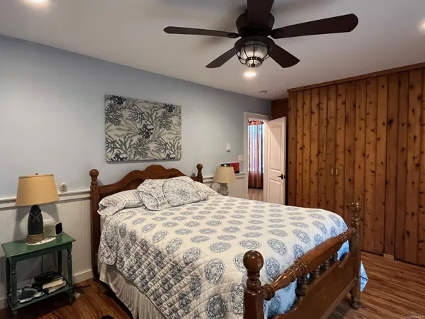 a bedroom with a bed and a chandelier