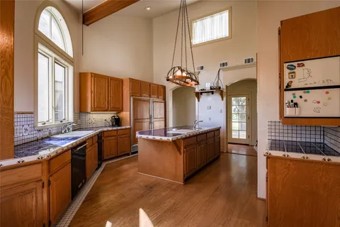 a room with pool table and windows